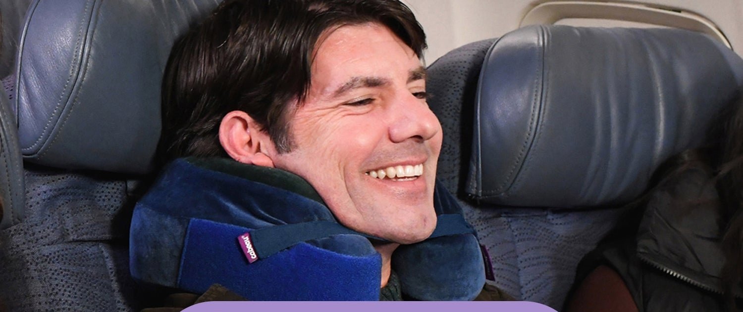 Cabeau Evolution Earth travel pillow worn around the neck on an airplane seat
