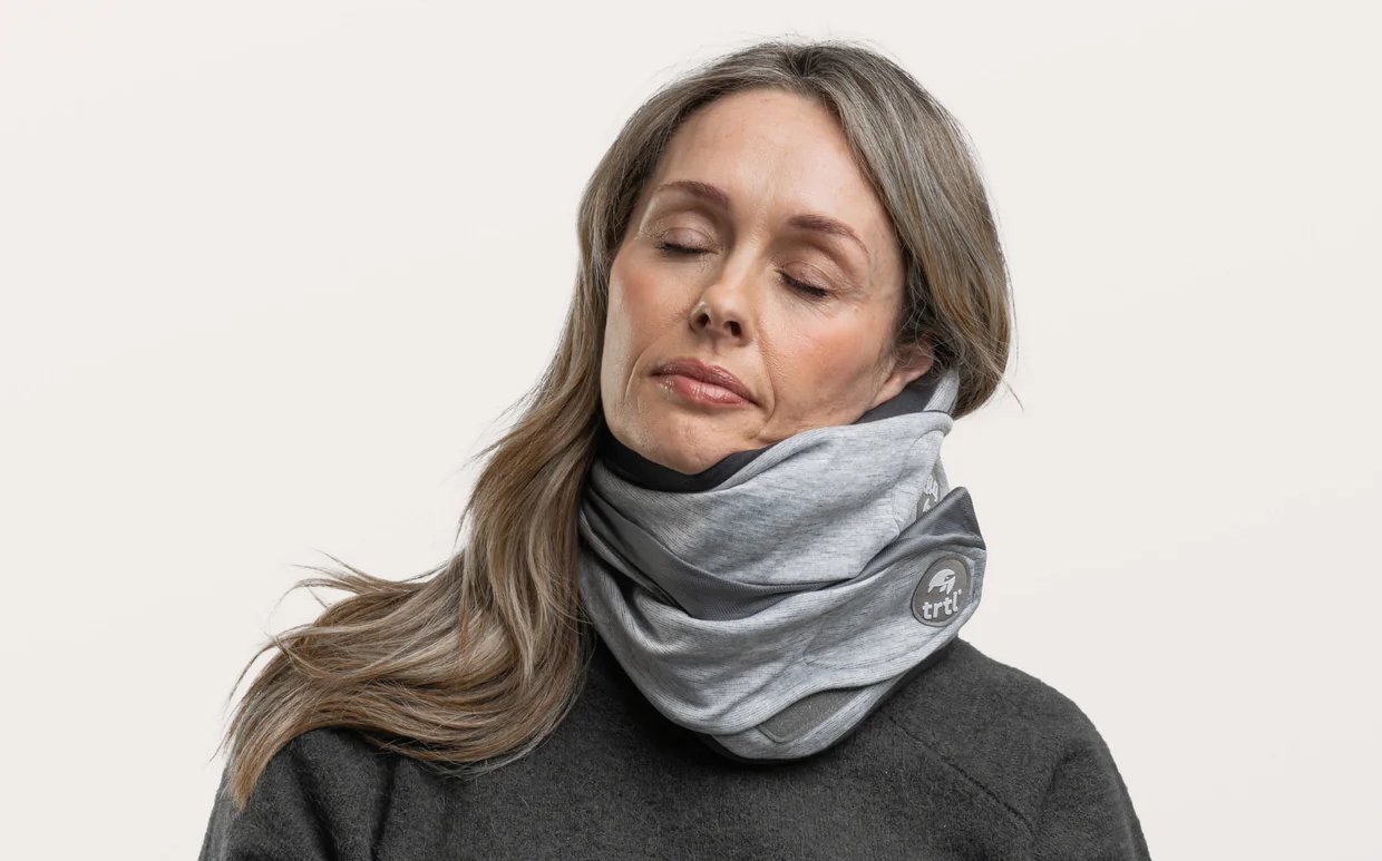 Trtl Pillow Plus adjustable travel neck support worn on airplane seat