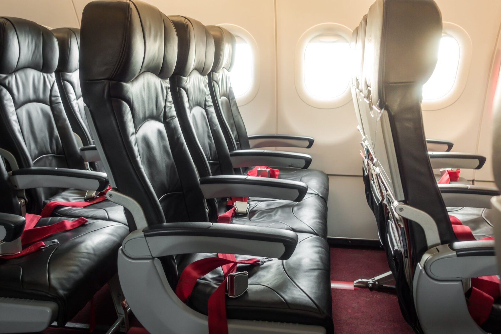 best seat to sleep on a plane showing window aisle and middle seat neck support differences